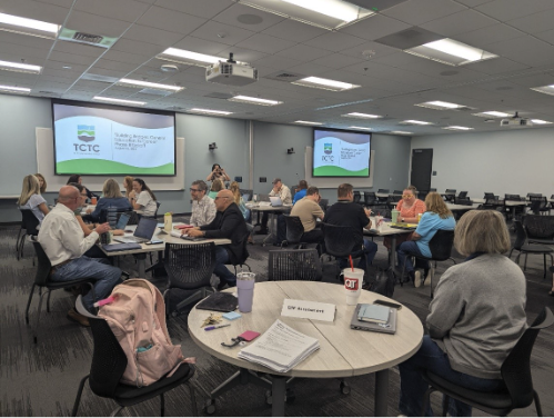 TCTC faculty sitting at desks during a QEP Meeting.